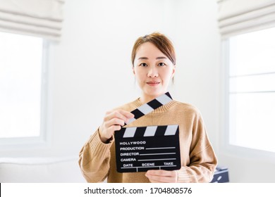 Entertainment Industry Crisis From Covid-19 Coronavirus Pandemic.Women Hands Holding Clapper Board For Making Video Cinema In Studio At Home.Movie Production Clapper Board Or Slate Film Concept.