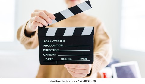 Entertainment Industry Crisis From Covid-19 Coronavirus Pandemic.Women Hands Holding Clapper Board For Making Video Cinema In Studio At Home.Movie Production Clapper Board Or Slate Film Concept.