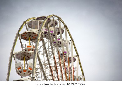 Entertainment industry for sunday holiday rides. Painted Ferris wheel for citizens and guests, big wheel metal construction