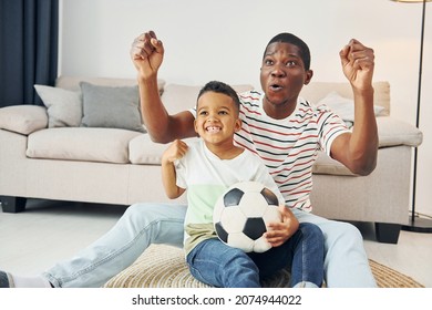 Entertainment for people. African american father with his young son at home. - Powered by Shutterstock