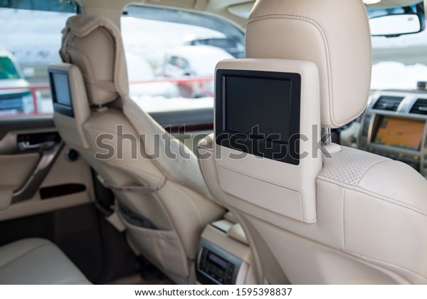 Entertainment system for rear passengers in a car\
with two monitors mounted on the backs of the front seats for\
watching TV, cartoons and computer\
games.
