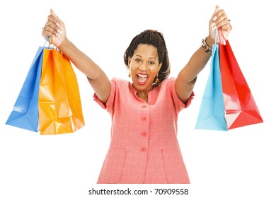 Enthusiastic african-american woman holding up her shopping bags.  Isolated on white.