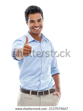 An enthusiastic approval. Studio shot of a young man giving the thumbs up sign isolated on white.