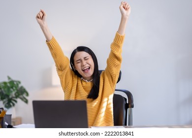 Enthusiastic asian woman rejoicing, excited, say yes, individual, looking happy and celebrating victory, champion dance, fist pump gesture, in home office, - Shutterstock ID 2222013841