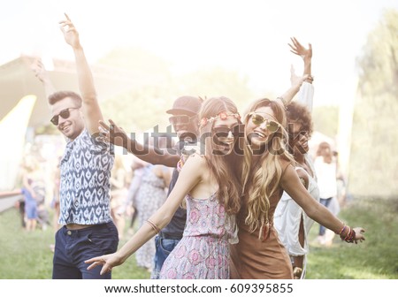 Enthusiastic crowd surfing at music festival 