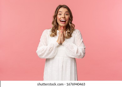 Enthusiastic And Excited, Happy Emotive Blond Girl Applause, Clasping Hands In Thrill And Amazement As Seeing Something Really Wonderful And Cool, Smiling As Dream Came True, Pink Background