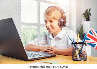 Enthusiastic kid in headphones studying English online