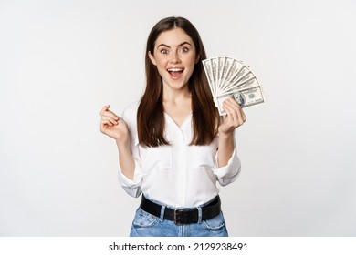 Enthusiastic Woman Showing Money, Cash And Smiling, Got Loan, Micro Credit, Standing Delighted Against White Background