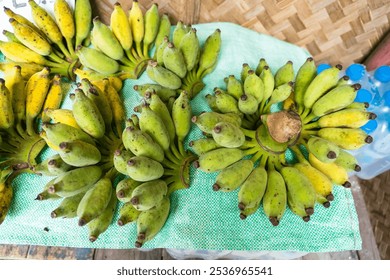 An enticing assortment of ripe Namwa bananas, reflecting the rich agricultural heritage of Thailand, perfect for health-conscious consumers seeking freshness. - Powered by Shutterstock