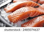 An enticing close-up image of fresh, glistening raw salmon fillets artfully arranged on a bed of ice