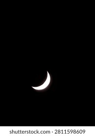 The entire background is completely solid black, devoid of stars or clouds, which emphasizes the brightness and shape of the moon.