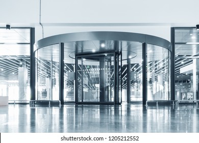 Entrance Aluminum Revolving Door and Interior Decoration Design, Architecture of Cylinder Rotate Access Doorway in Front of Airport Hall. Aluminium Door Frame and Transparentcy Tempered Glass