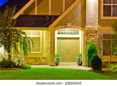 Entrance of a big luxury house at dusk, night in suburbs of Vancouver, Canada