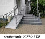 The entrance to the building is equipped with stairs and a ramp