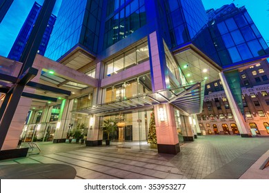 Entrance To The Building Lobby. Night Scene Of Modern Colorful City Life With Skyscrapers, Highrise Buildings. Vancouver Downtown  At Night.