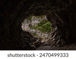 entrance to a cave in the mountain. Mountain cave entrance. with the view of forest. a mountain landscape in spain