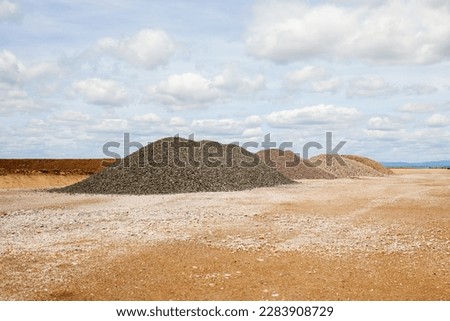 entrance construction site, driveway of building site. Pile of sand and Gravel for construction. limestone materials for construction industry.