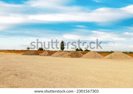Entrance construction site, driveway of building site. Pile of sand and Gravel for construction. Limestone materials for construction industry.