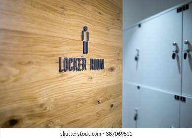 Entrance Door To A Men Locker Room In The Gym.Spa,swimming Pool,gym Locker Room Door With Caption Sign And Little Grey Lockers In The Background.Sportsmen Locker Room.Sport Changing Room