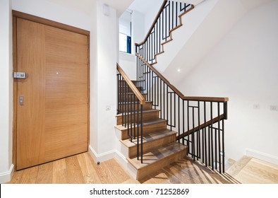 entrance door and modern staircase with a nice wooden finish