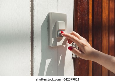 At The Entrance Door, Woman Hand Rings At The Door Bell