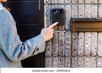 At The Entrance Door, Woman Ringing At The Door Bell