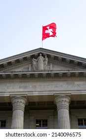 Entrance of federal supreme court of Switzerland with Swiss flag and the latin words lex, justitia and pat City of Lausanne. Photo taken March 18th, 2022, Lausanne, Switzerland.