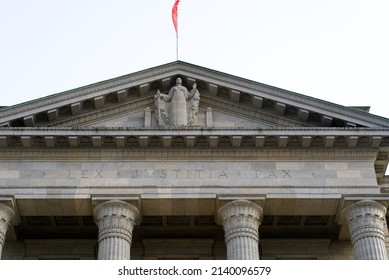 Entrance of federal supreme court of Switzerland with Swiss flag and the latin words lex, justitia and pat City of Lausanne. Photo taken March 18th, 2022, Lausanne, Switzerland.