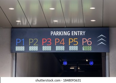 Entrance To The Garage Parking Lot With Floor Level Numbers Signs Above.