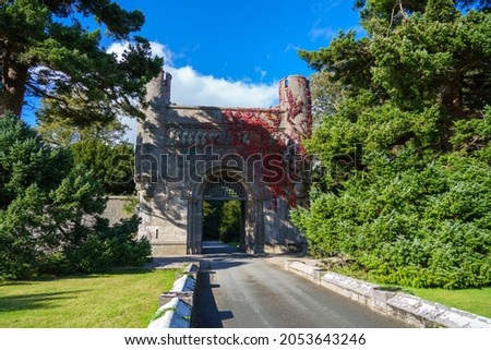 Entrance Gate House to Penrhyn Castle and Gardens (National Trust) with beautiful red creeping virginia (Parthenocissus quinquefolia) Bangor Wales UK