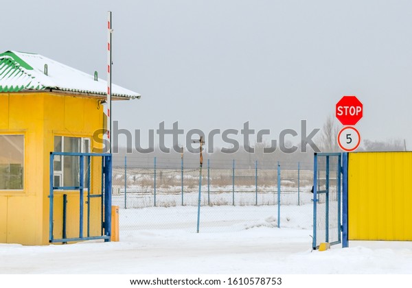 Entrance to the guarded territory,\
security checkpoint, raised barrier, stop sign and speed\
limit.