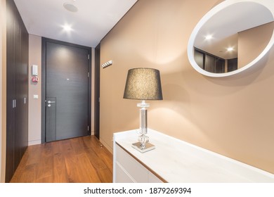 Entrance Hall In The Bright Luxury Apartment. Hallway Dresser With Lamp