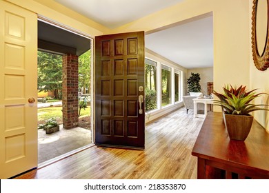 Entrance Hallway With Cabinet. View Of Entrance Porch Through Open Door