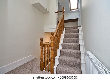 Entrance Hallway And Landing Design With Carpet Runner And Natural Wood Banister