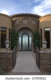 Entrance to home with stonework and iron doorway