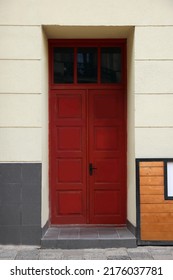 Entrance Of House With Beautiful Red Door And Transom Window