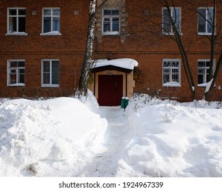 Entrance into an old brick living house after heavy snowfall in Balashikha, Russia.