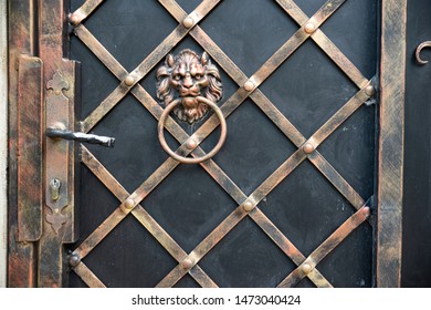 Entrance Iron Gate With Forging Elements And Handle And Shock Bell In The Form Of A Lion