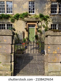 Entrance With An Iron Gate And Stone Exterior Of A Beautiful Old English Town House