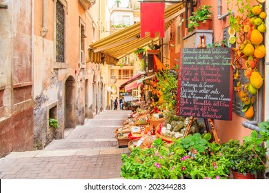 Entrance to local shop in Taormina, Sicily. Writing on the black table lists itmes on promotion.