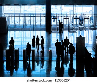 Entrance to modern building and people silhouettes