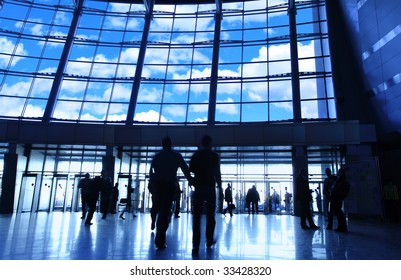 Entrance To Modern Building And People Silhouettes