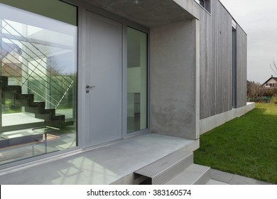 Entrance of a modern house in concrete and wood, outside