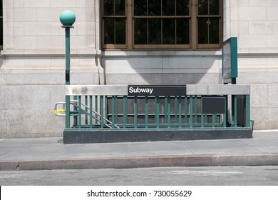 Entrance To The New York City Subway. Stairs Leading Down To A Subway Station In Manhattan. Iconic Green Lamps That Mark The Entrance To A Subway Station. No People.