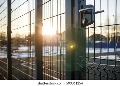 entrance to the playground of fence and the wicket of the welded wire mesh green color with a metal lock and handle