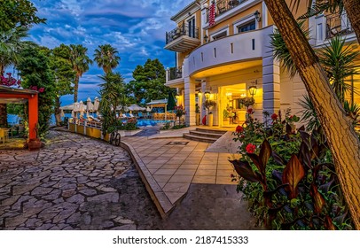 Entrance To The Resort Hotel By The Sea In The Evening. Resort Hotel With Swimming Pool. Resort Hotel Entrance. Resort Hotel In Evening