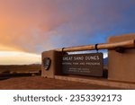 The entrance sign of Great Sand Dunes National Park and Preserve at sunset, Alamosa, Colorado. The park is in southern Colorado and known for huge dunes.
