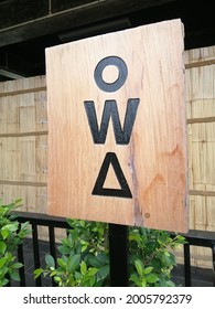 The Entrance Sign To The Women's Restroom Is Made Of Wood