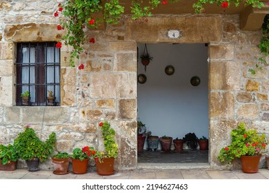 Entrance To A Small Rural Town House With Flower Pots