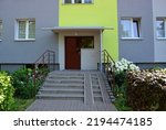 The entrance to the staircase with the close door - view of the apartment block